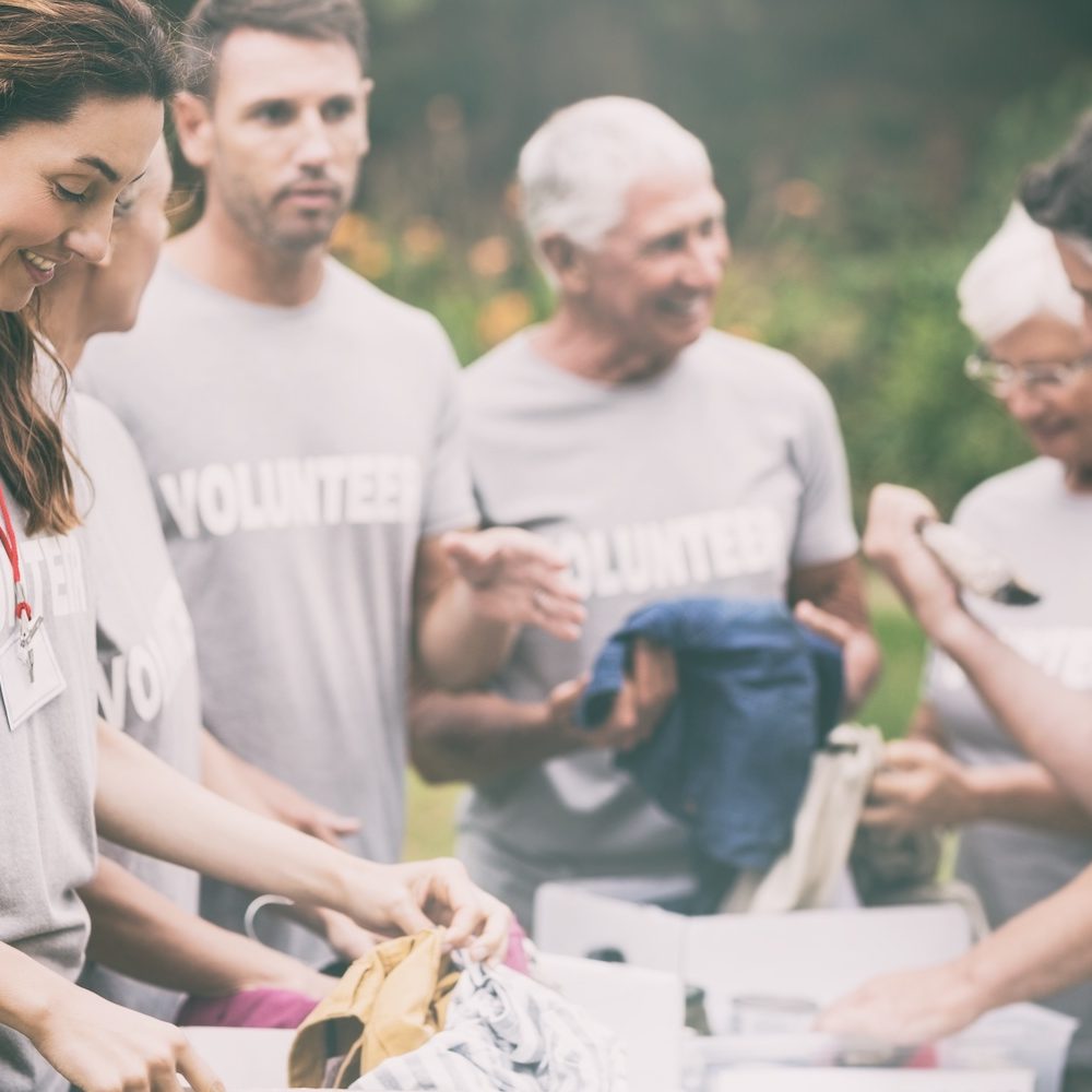 Happy volunteer looking at donation box